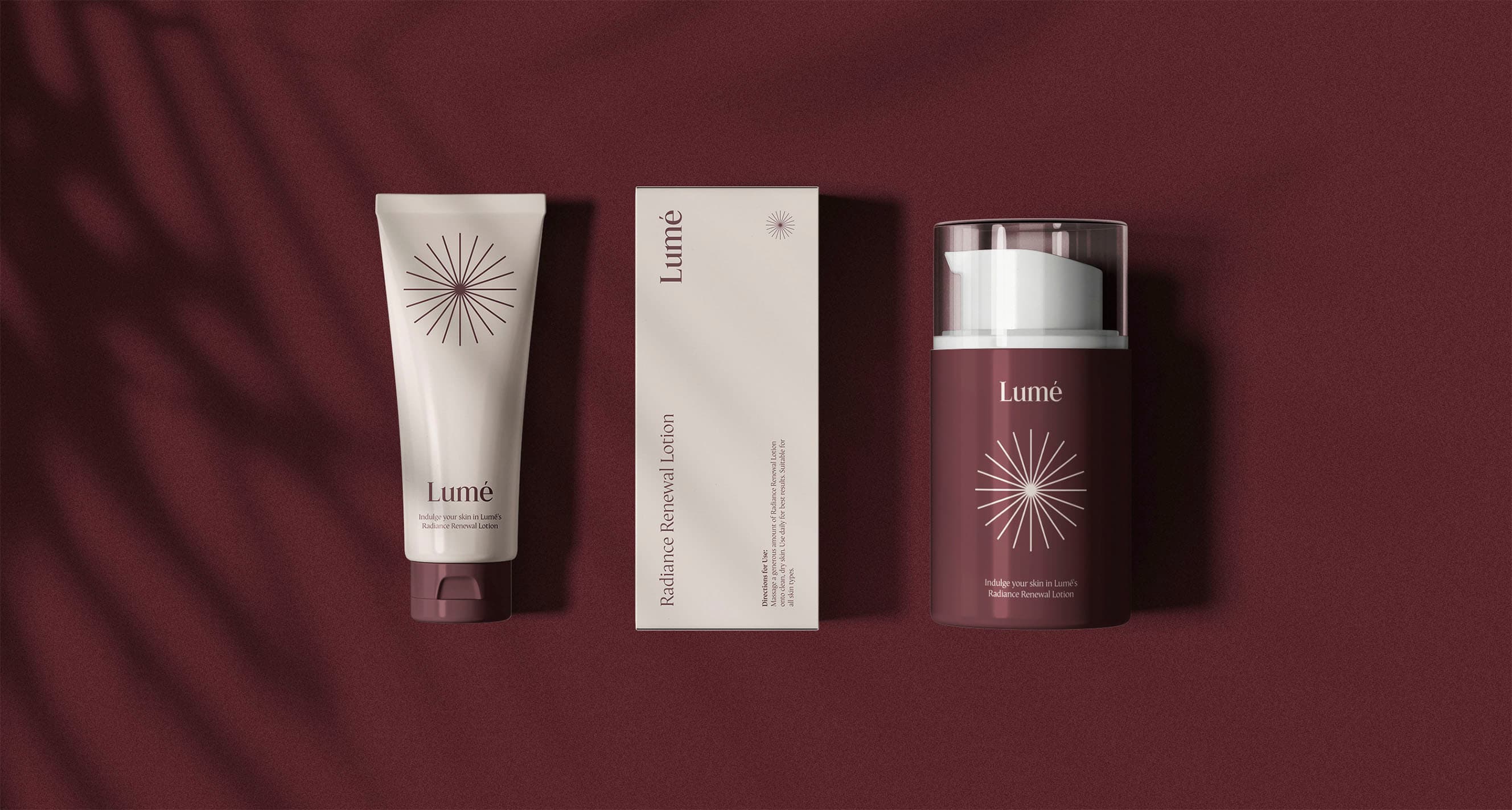 Lumé Skincare product system on oxblood: tube, carton, and airless pump bottle